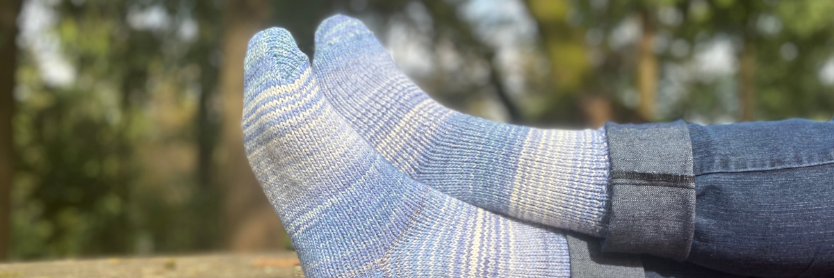 Premium wool blue socks on the stone table, premium socks, hugged collection, sideways